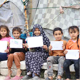 Children holding drawings